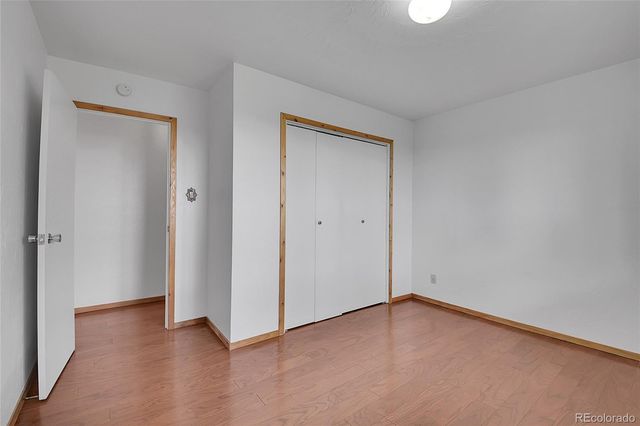 a view of an empty room and closet area