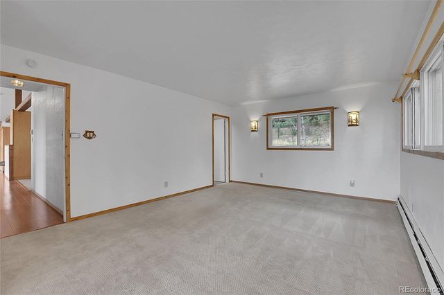 an empty room with windows and closet