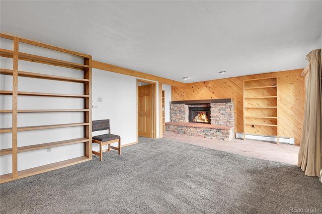 a view of an empty room with a fireplace and a window