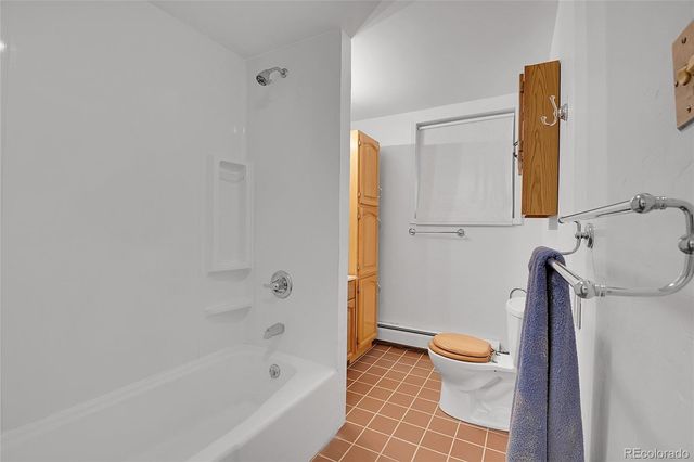 a bathroom with a toilet and a bathtub