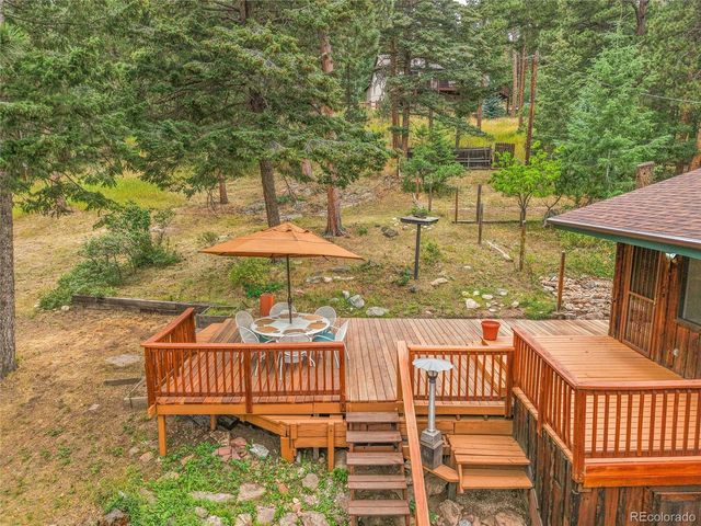 a view of a wooden deck and a patio with a yard
