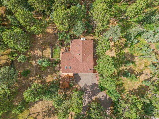 an aerial view of a house with yard and outdoor seating