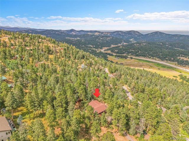 a aerial view of residential houses with swimming pool and mountain view