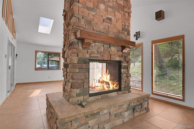a living room with fireplace furniture and a window