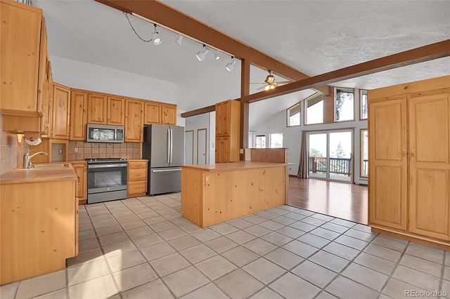 a kitchen with a sink cabinets and stainless steel appliances