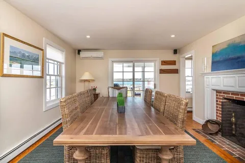 a view of a living room and dining room with wooden floor