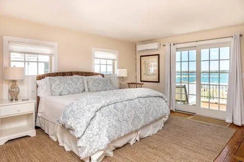 a bedroom with a large bed and a large window