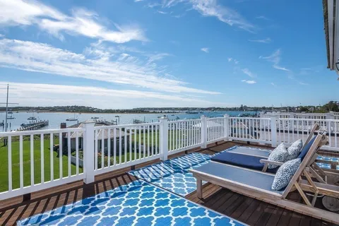 a view of a balcony with wooden floor and city view