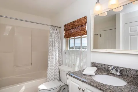 a bedroom with bed and a window