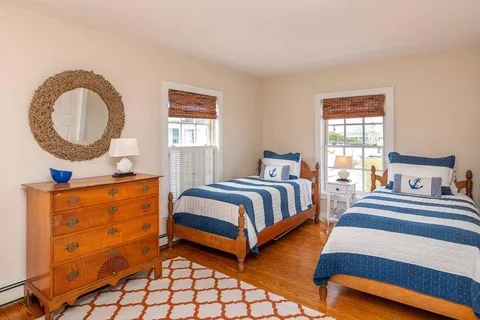 a bed sitting in a bedroom next to a cabinet