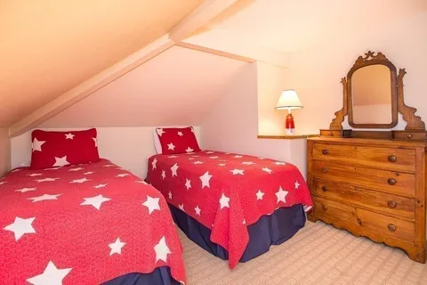 a bedroom with a bed and a night stand