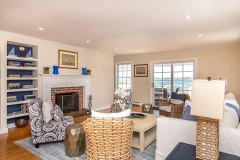 a living room with furniture fireplace and window