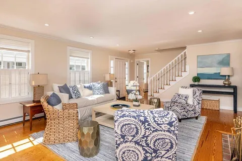 a living room with furniture or couch and a wooden floor