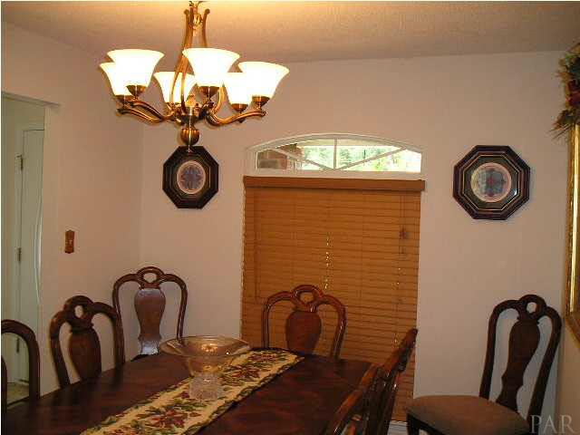 4178 Audiss Road Milton, FL 32583 - Photo 11 of 19 Formal Dining Room with custom faux wood blinds and upgraded chandelier