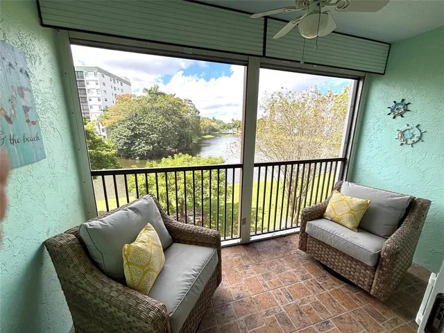 a balcony with furniture and a potted plant