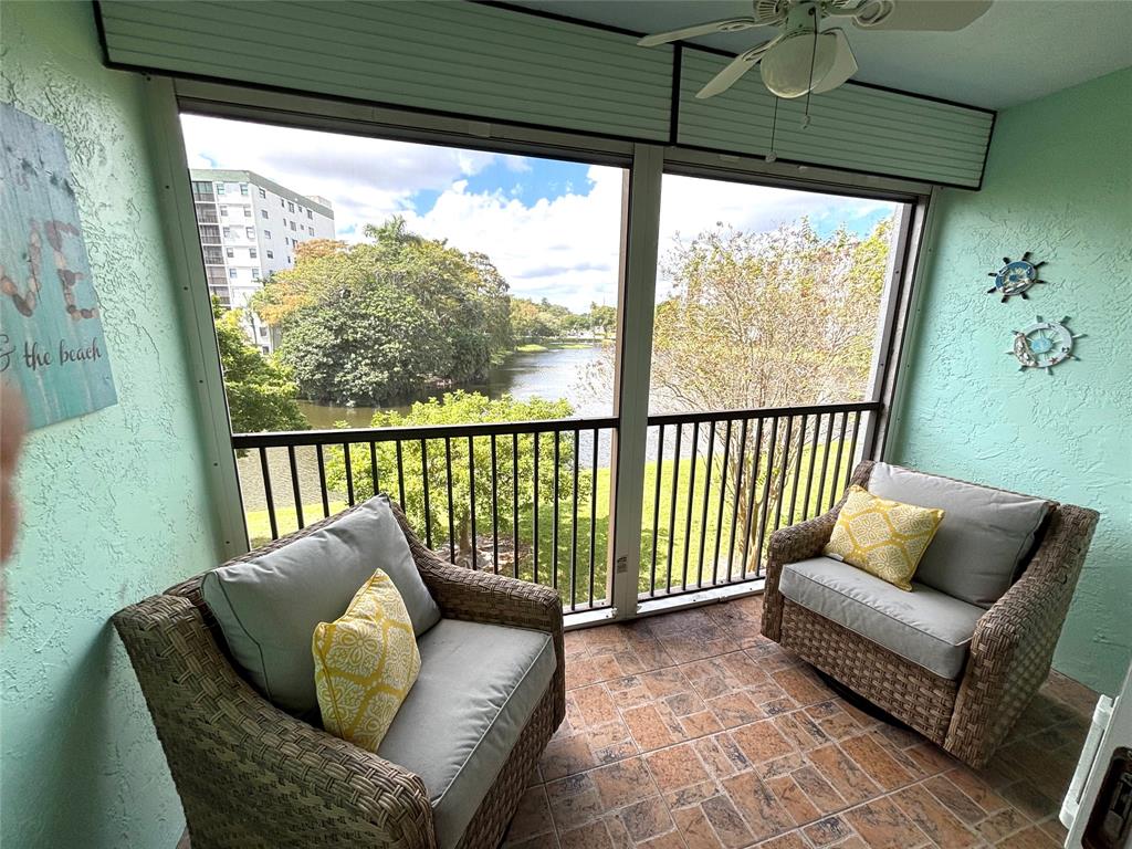 a balcony with furniture and a potted plant