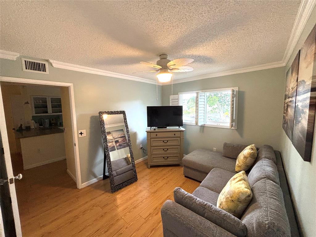 2236 North Cypress Bend Drive, Unit 304 Pompano Beach, FL 33069 - Photo 14 of 17 a living room with furniture and a flat screen tv