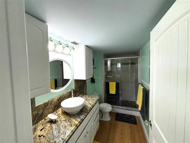 a bathroom with a sink mirror toilet and shower