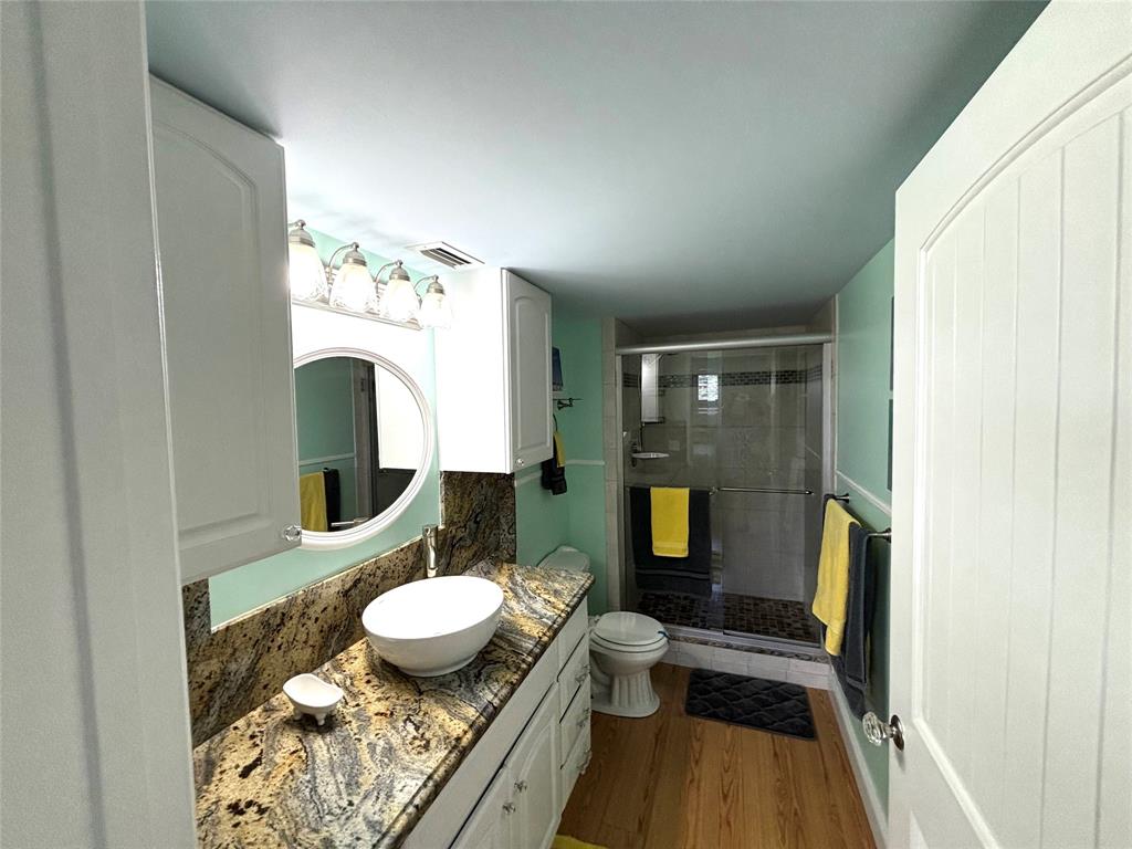 2236 North Cypress Bend Drive, Unit 304 Pompano Beach, FL 33069 - Photo 4 of 17 a bathroom with a sink mirror toilet and shower