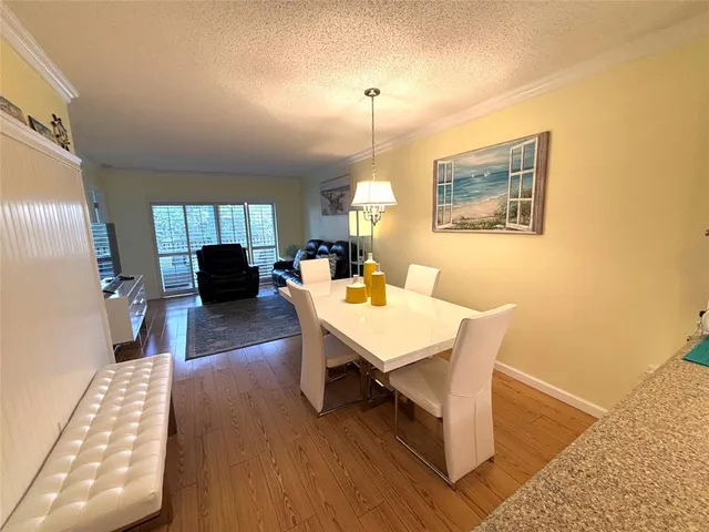 a living room with furniture a rug and a chandelier