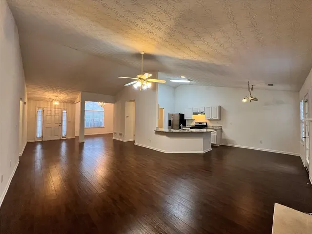 a view of a living room and kitchen with hardwood floor