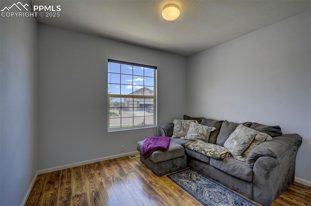 12593 Pine Valley Circle Peyton, CO 80831 - Photo 12 of 17 Living area featuring wood finished floors and baseboards