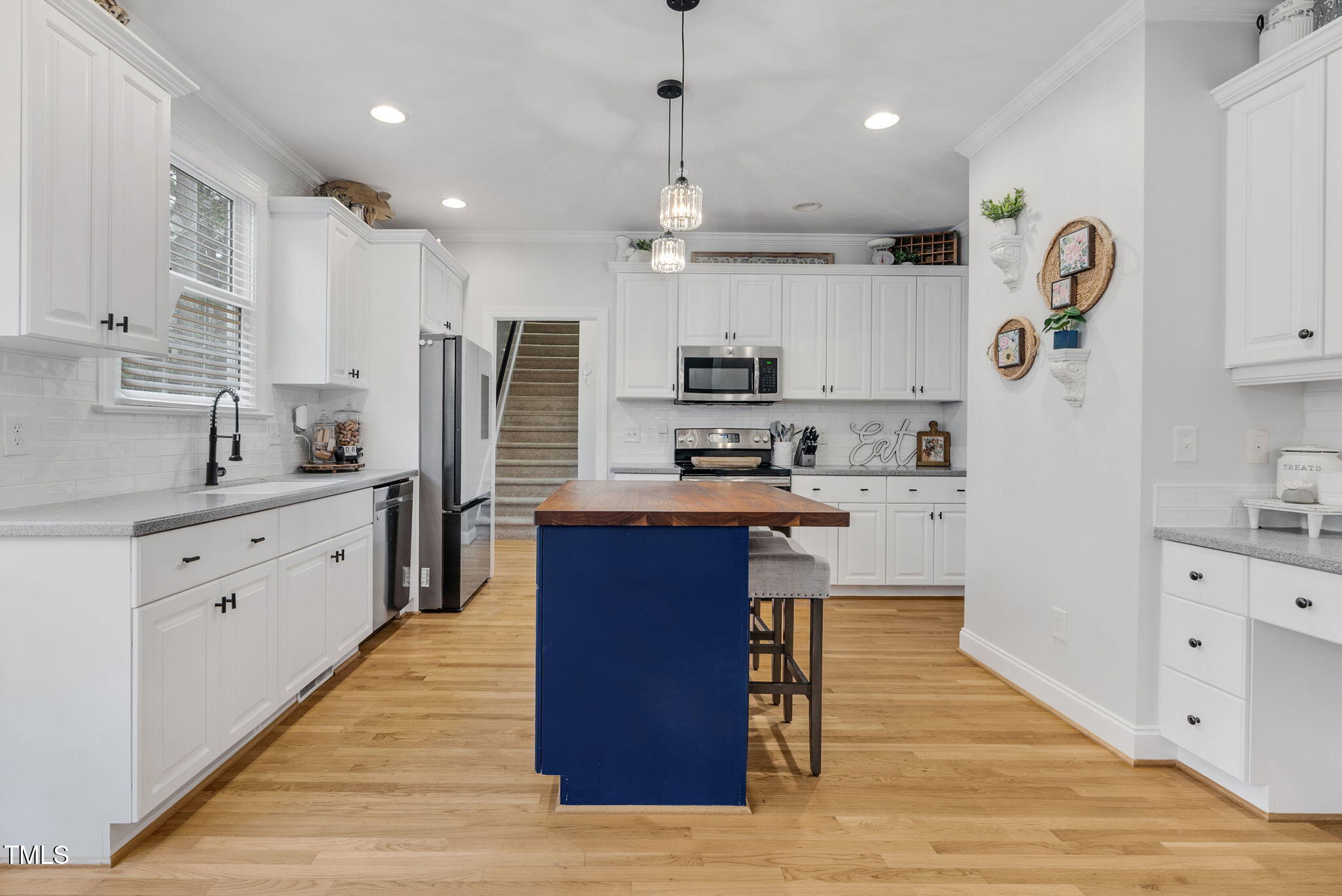 1113 Colonial Club Road Wake Forest, NC 27587 - Photo 17 of 41 a large kitchen with stainless steel appliances kitchen island granite countertop a stove a sink dishwasher and a refrigerator with wooden floor