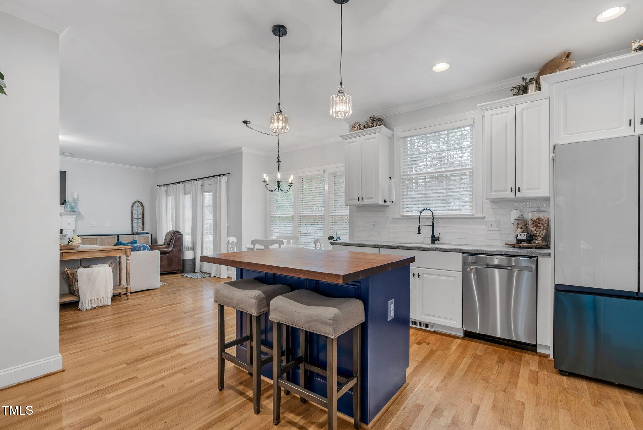1113 Colonial Club Road Wake Forest, NC 27587 - Photo 21 of 41 a kitchen with stainless steel appliances granite countertop a table chairs stove a sink dishwasher a refrigerator and cabinets with wooden floor