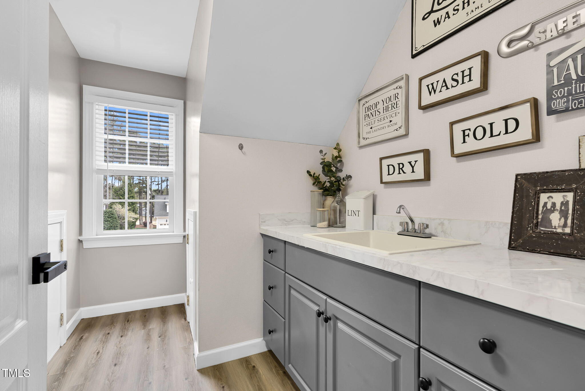1113 Colonial Club Road Wake Forest, NC 27587 - Photo 25 of 41 a hallway with a sink and cabinets