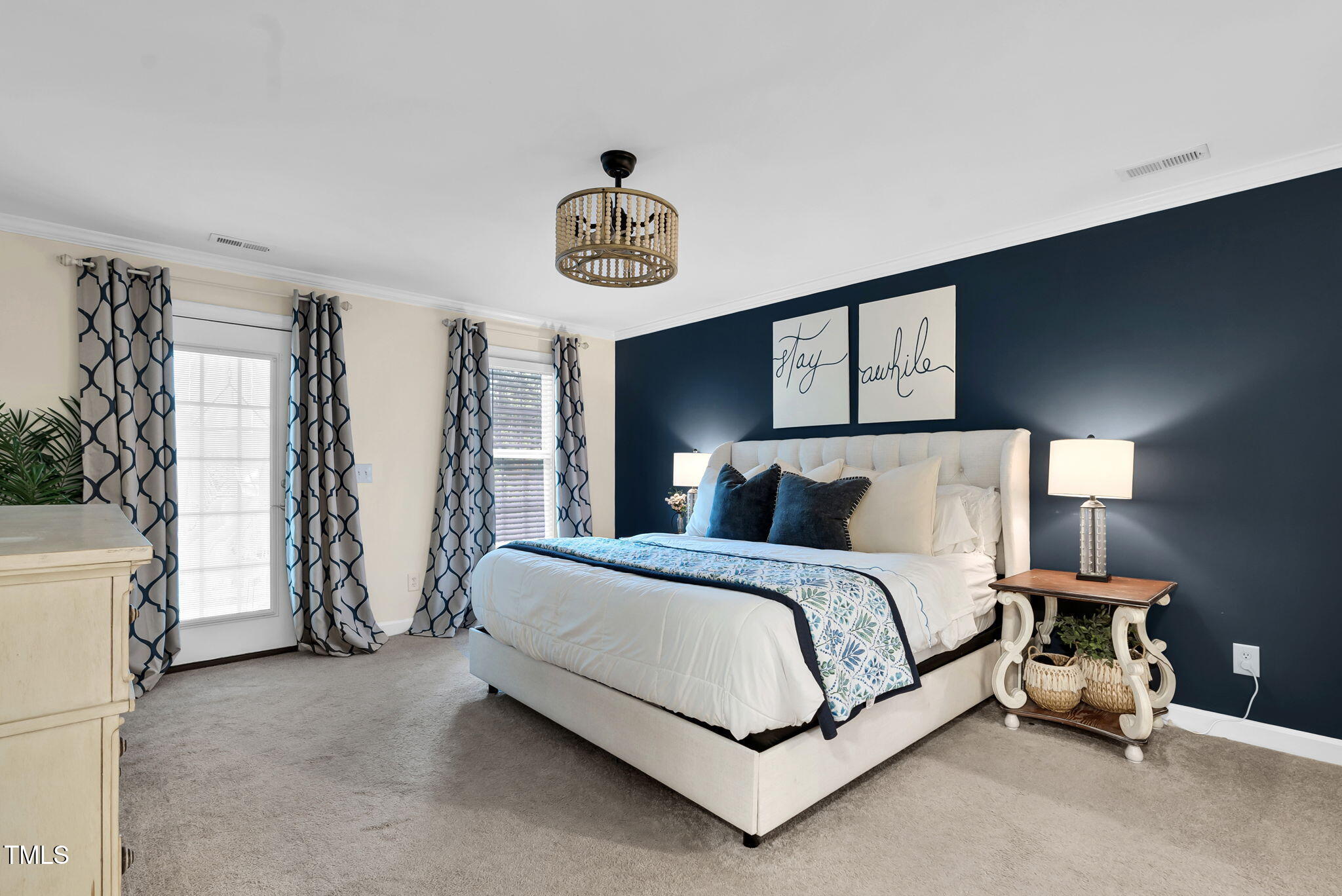 1113 Colonial Club Road Wake Forest, NC 27587 - Photo 32 of 41 a spacious bedroom with a bed and a chandelier