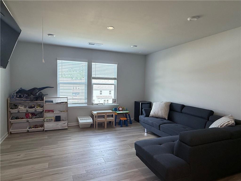 1543 Maston Road Auburn, GA 30011 - Photo 15 of 33 a living room with furniture and a wooden floor