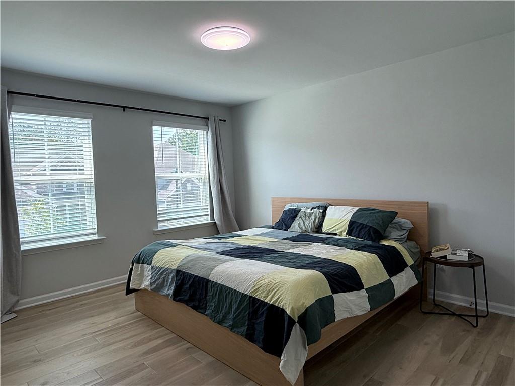 1543 Maston Road Auburn, GA 30011 - Photo 19 of 33 a bedroom with a bed lamp and window