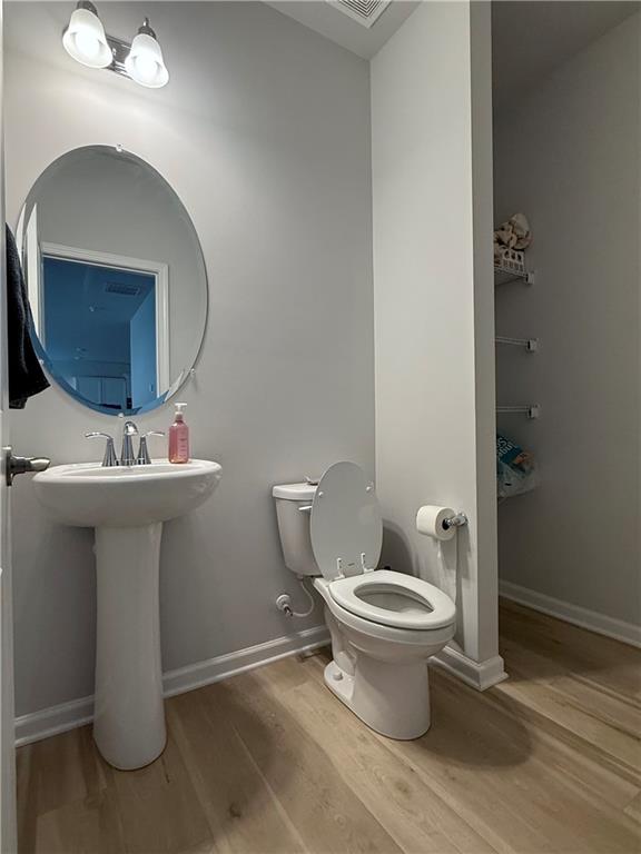 1543 Maston Road Auburn, GA 30011 - Photo 25 of 33 a bathroom with a toilet sink and mirror