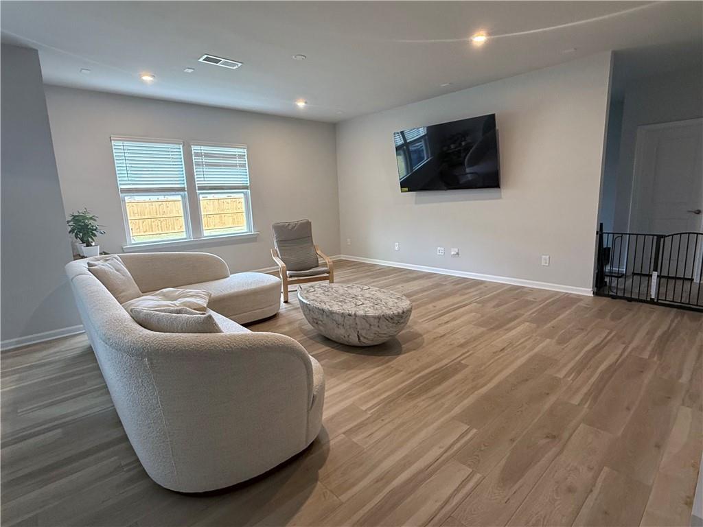 1543 Maston Road Auburn, GA 30011 - Photo 10 of 33 a living room with couches and a flat screen tv