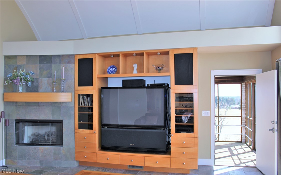 13720 Hale Road Burton, OH 44021 - Photo 15 of 35 Entertainment Center in the Great Room with a barrel ceiling and a gas fireplace. Opens to the screened in Porch.