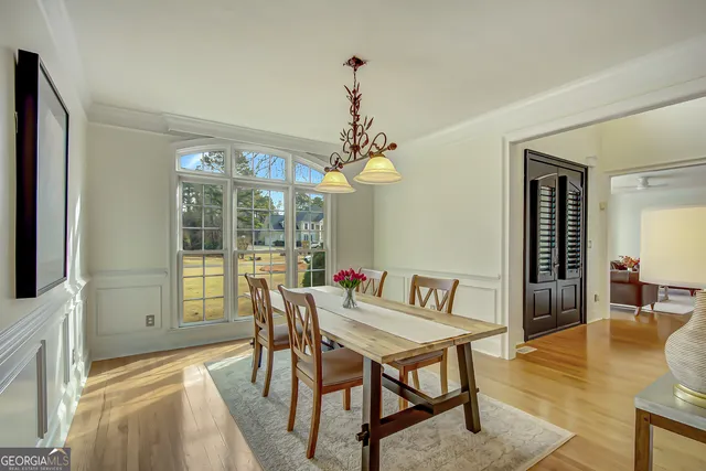 a view of a dining room with furniture window and wooden floor