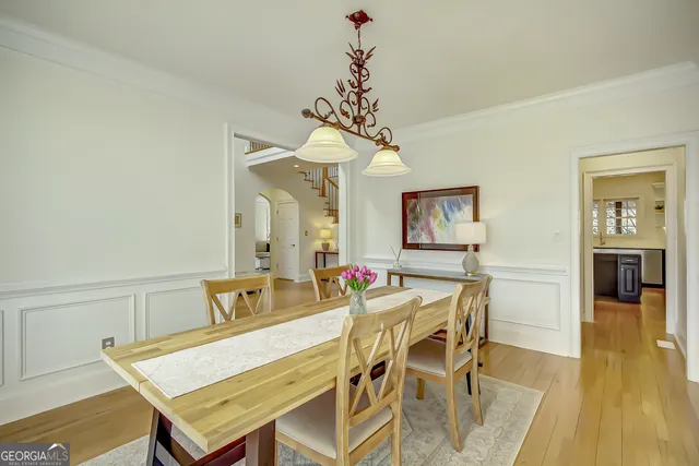 a view of a dining room with furniture and a potted plant