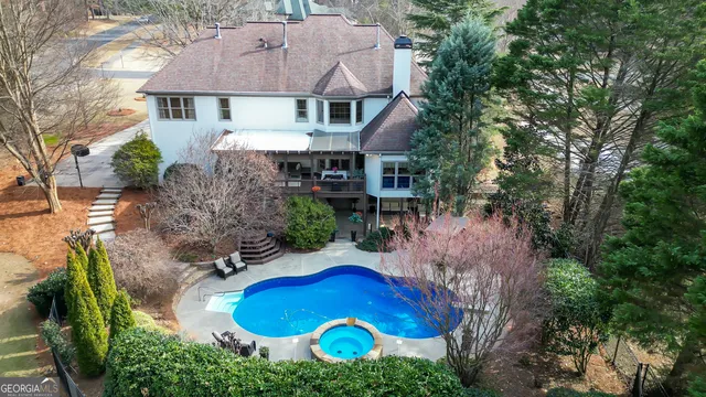 a view of a white house with a large tree