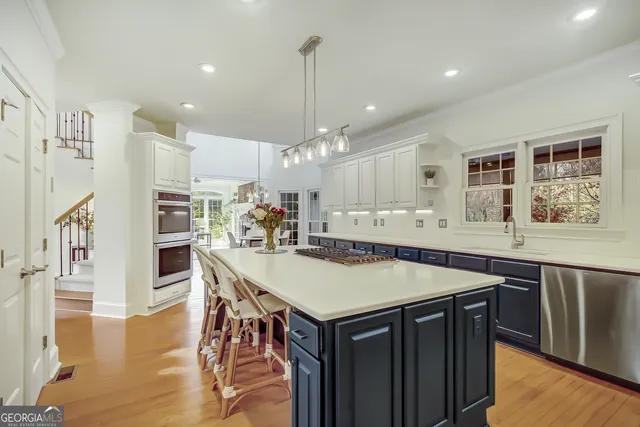 a spacious bathroom with a double vanity sink a mirror and a bathtub