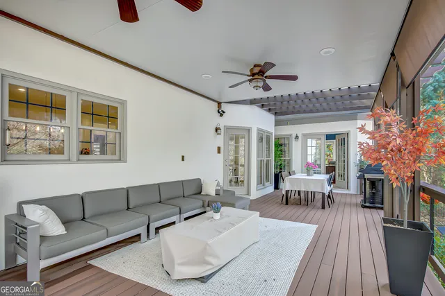 a living room with furniture and a floor to ceiling window