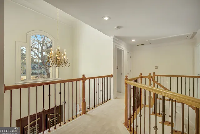a view of pool with lawn chairs under an umbrella