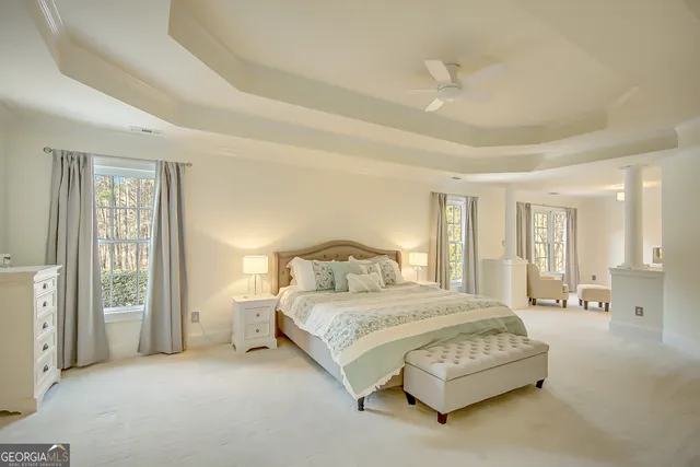 a view of swimming pool with lawn chairs and plants