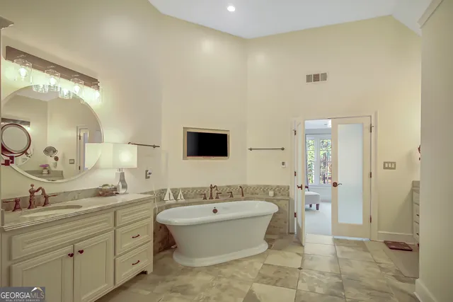 a front view of a house with a yard and trees