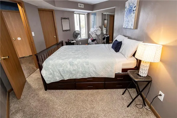a bedroom with a bed and window