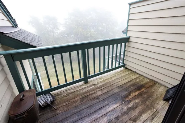 a view of a balcony with wooden floor