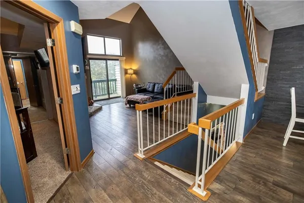 a view of entryway with wooden floor and windows