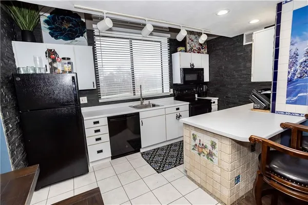 a kitchen with stainless steel appliances a refrigerator sink and cabinets