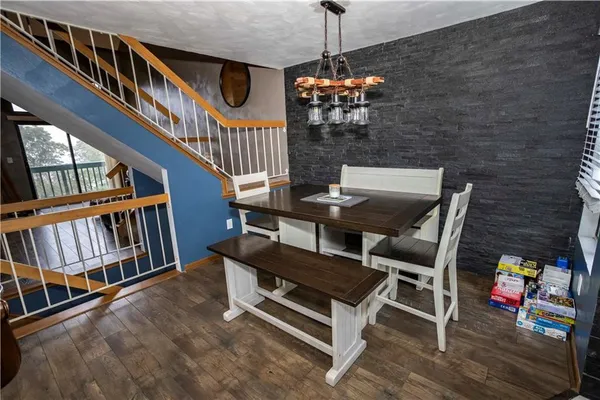 a view of a livingroom with furniture staircase and front view of a house
