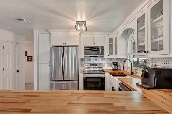 a kitchen with stainless steel appliances granite countertop a sink stove and cabinets
