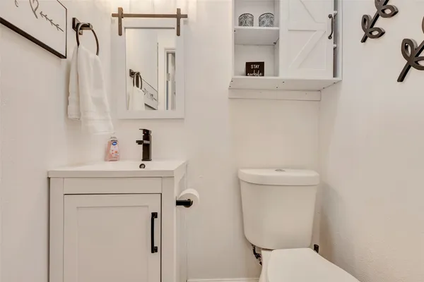 a bedroom with a bed and a flat tv screen on dresser